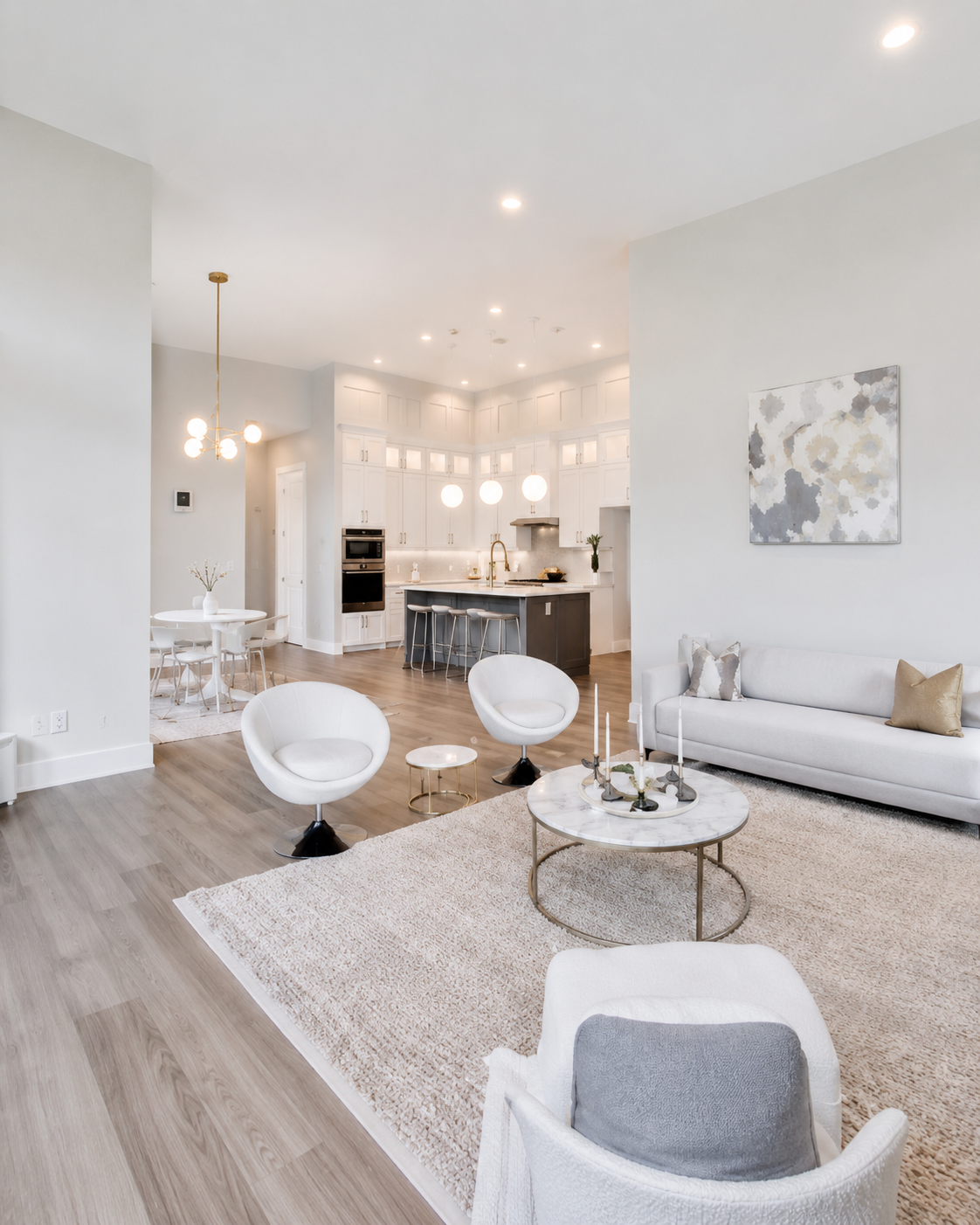 Bright open-concept living room connected to a custom white kitchen